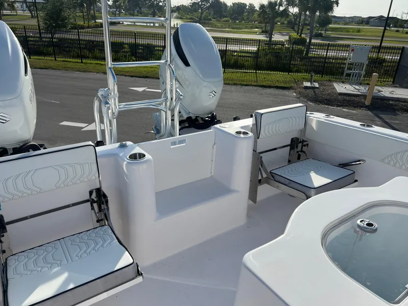 Slide: The Image of 2025 Twin Vee 280 GFX2 CC boat interior with seating and dual engines. - 11