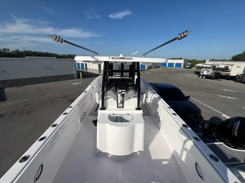 Slide: The Image of 2025 Twin Vee 280 GFX2 CC boat with center console in a parking area. - 12