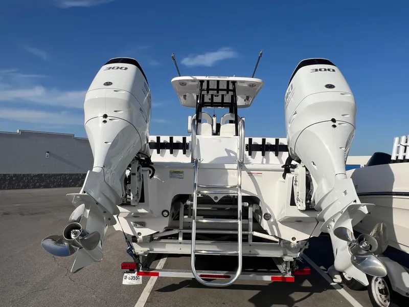 Slide: The Image of 2025 Twin Vee 280 GFX2 CC boat with dual 300 horsepower engines, rear view. - 14