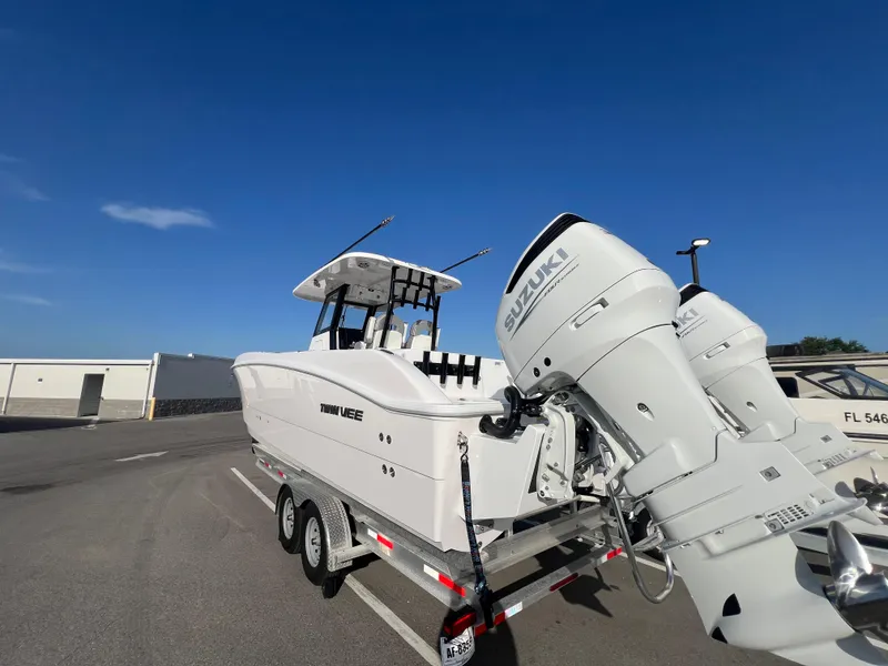 Slide: The Image of 2025 Twin Vee 280 GFX2 CC boat on trailer with dual Suzuki outboard motors. - 15
