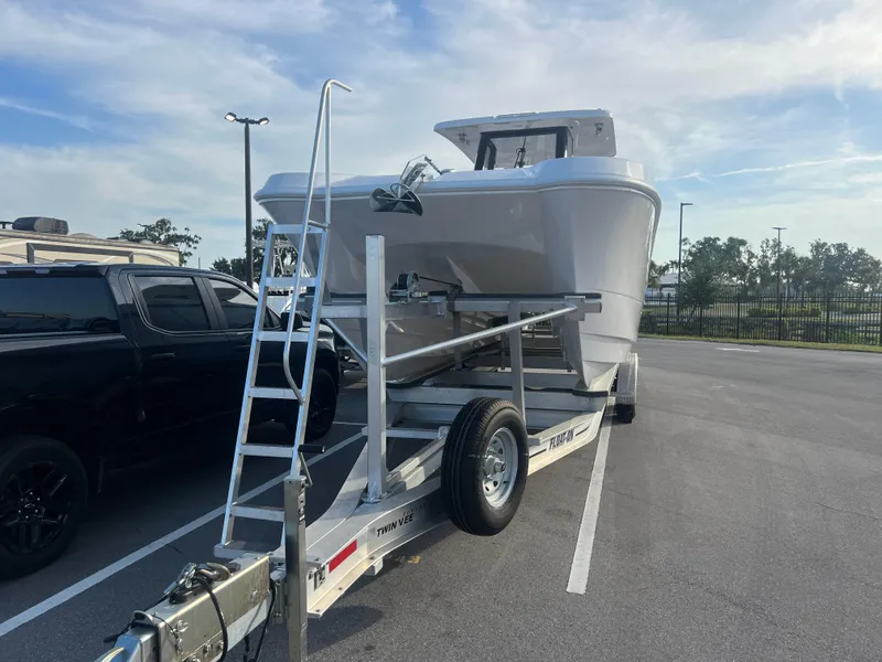 Slide: The Image of 2025 Twin Vee 280 GFX2 CC boat on trailer in parking lot. - 2
