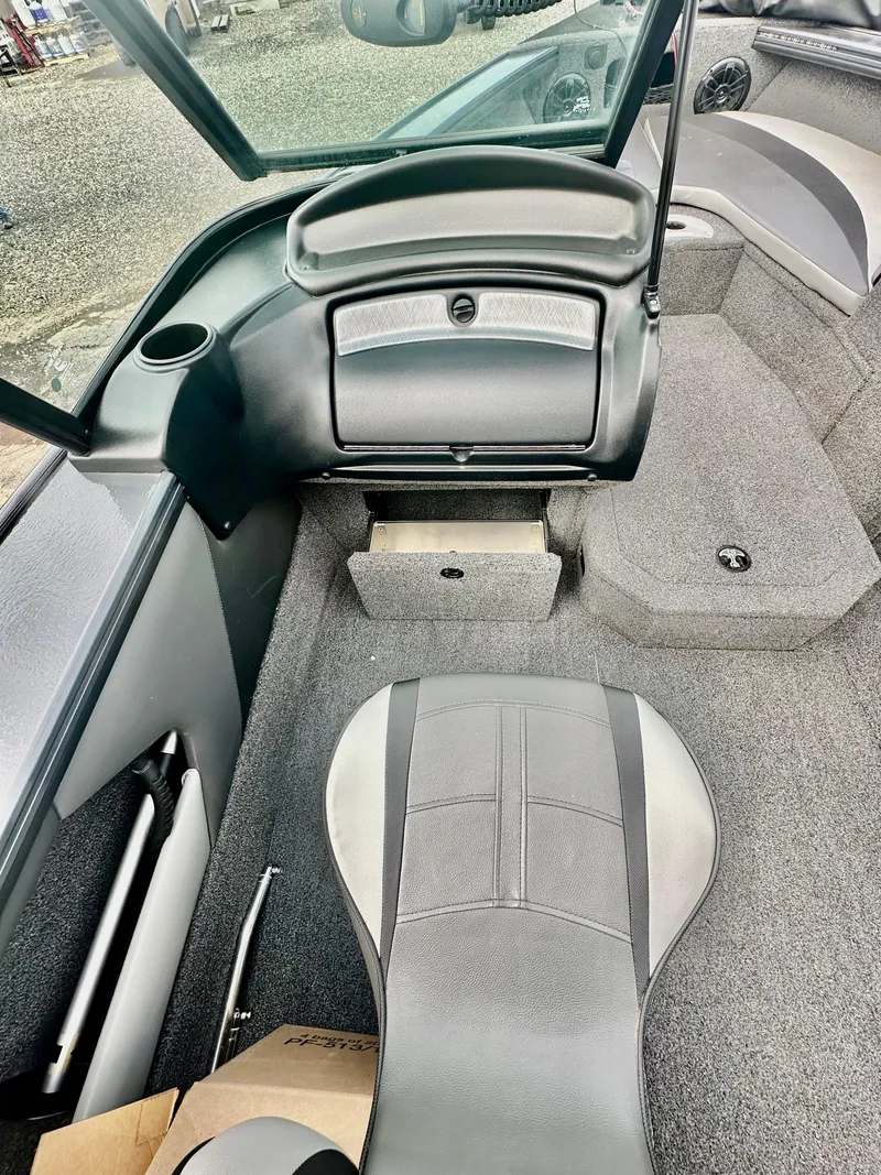 Slide: The Image of 2021 Lund 1875 Crossover XS boat interior with seating and storage compartments. - 11