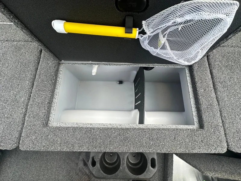 Slide: The Image of 2021 Lund 1875 Crossover XS boat storage compartment with net and cup holders. - 16