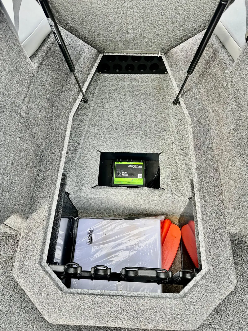 Slide: The Image of 2021 Lund 1875 Crossover XS boat storage compartment with organized gear and accessories. - 19