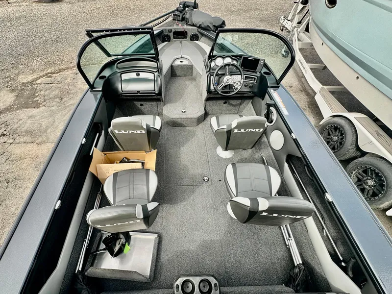 Slide: The Image of 2021 Lund 1875 Crossover XS boat interior with four seats and steering console. - 8