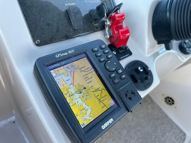 Slide: The Image of Garmin GPSmap 182C on 2004 Cruisers Express boat dashboard, displaying nautical map. - 16