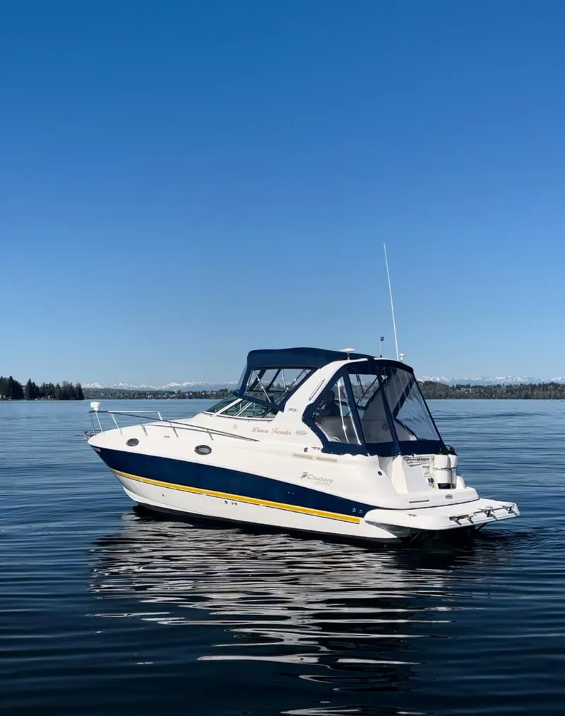 Slide: The Image of 2004 Cruisers Express boat on calm water under clear blue sky. - 2