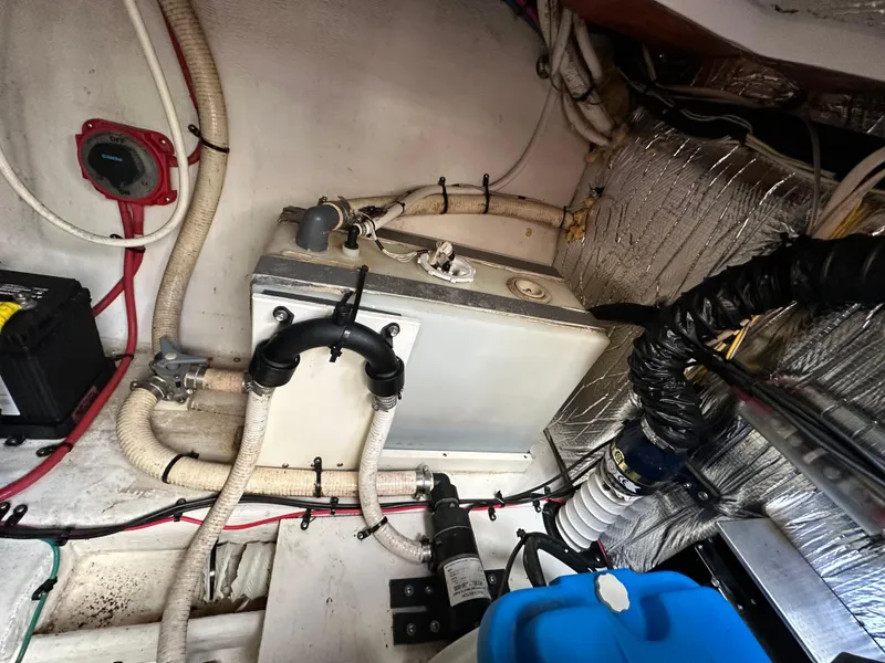 Slide: The Image of 2004 Cruisers Express engine room with wiring, hoses, and equipment. - 32