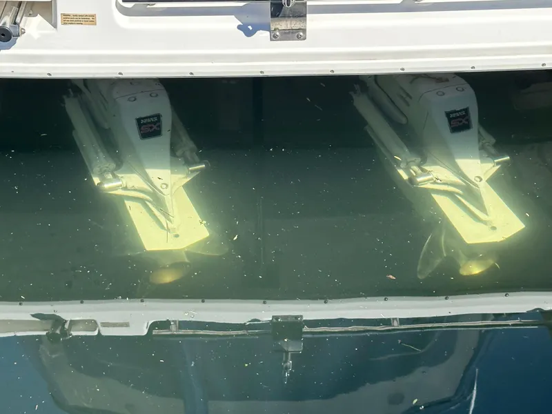 Slide: The Image of 2004 Cruisers Express boat propellers submerged in clear water. - 34