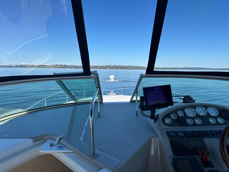 Slide: The Image of 2004 Cruisers Express boat dashboard with clear lake view and blue sky. - 9