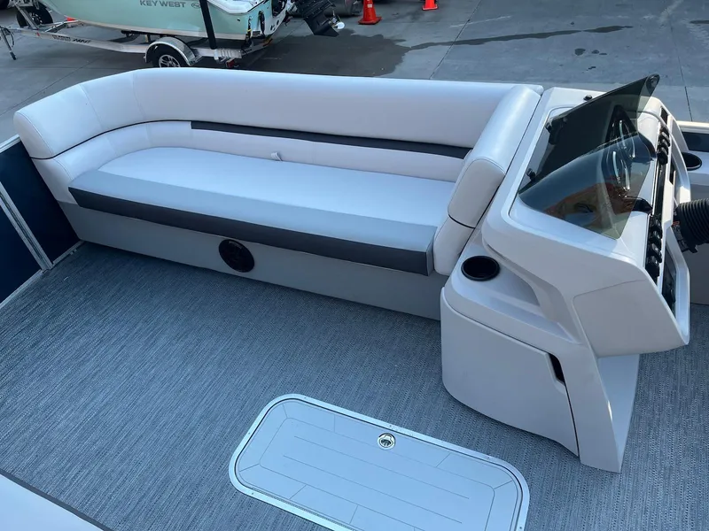 Slide: The Image of 2024 Godfrey SWEETWATER 2286 SB boat interior with sleek seating and modern console design. - 11