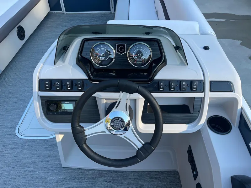 Slide: The Image of 2024 Godfrey SWEETWATER 2286 SB boat dashboard with steering wheel and control panel. - 5