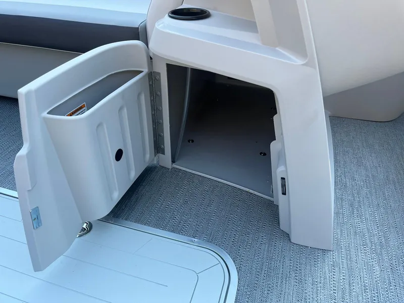Slide: The Image of Open storage compartment on 2024 Godfrey SWEETWATER 2286 SB boat, featuring carpeted flooring. - 9