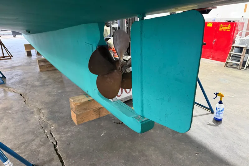 Slide: The Image of 1990 BEALS Lobster Boat propeller and rudder in a workshop setting. - 22