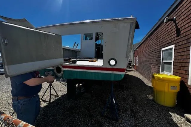 Slide: The Image of 1990 Downeast Beal Lobster Boat under repair on gravel surface. - 27
