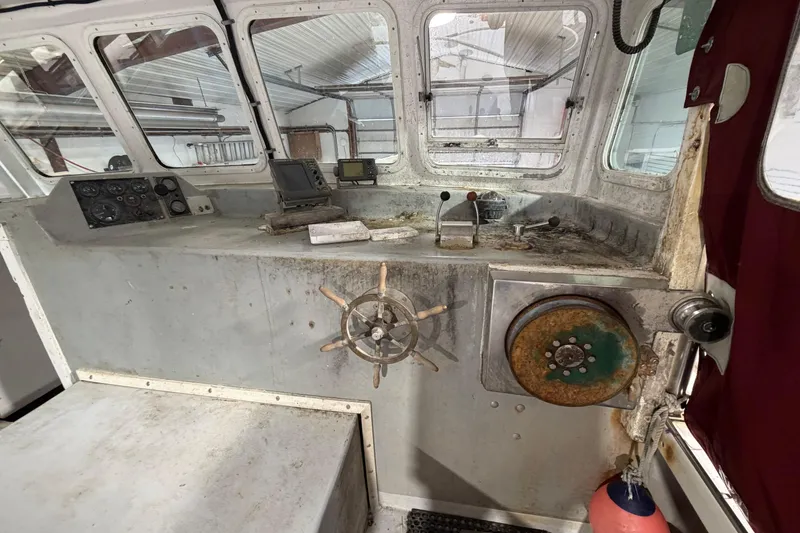 Slide: The Image of Interior of a 1990 BEALS Lobster Boat, featuring steering wheel and control panel. - 3