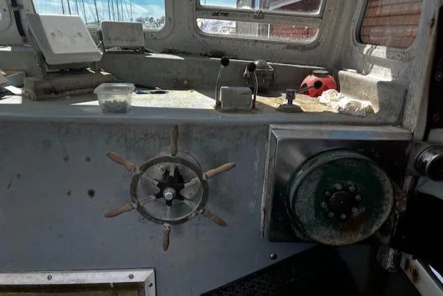 Slide: The Image of Interior of 1990 Downeast Beal Lobster Boat with steering wheel and controls. - 4