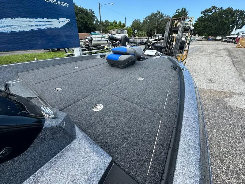 Slide: The Image of 2025 Ranger Z185 boat deck with storage compartments and seating, displayed outdoors. - 4