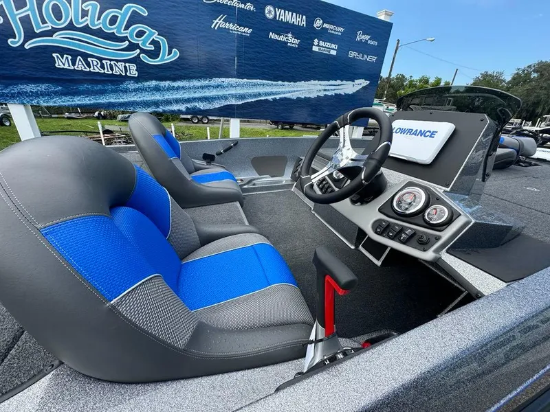 Slide: The Image of 2025 Ranger Z185 boat interior with blue seats and modern dashboard at Holiday Marine. - 5