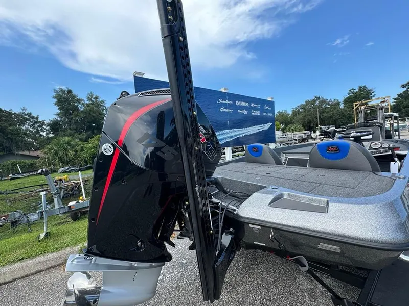 Slide: The Image of 2025 Ranger Z185 boat with powerful outboard motor, parked outdoors under a clear sky. - 8