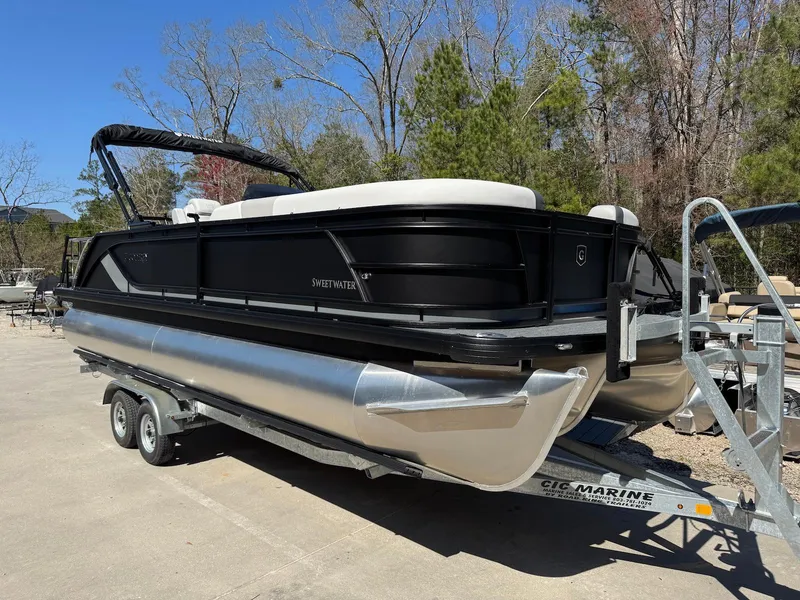 The Image of 2025 Godfrey Sweetwater 2286 SFLC pontoon boat on trailer, parked outdoors. - 1