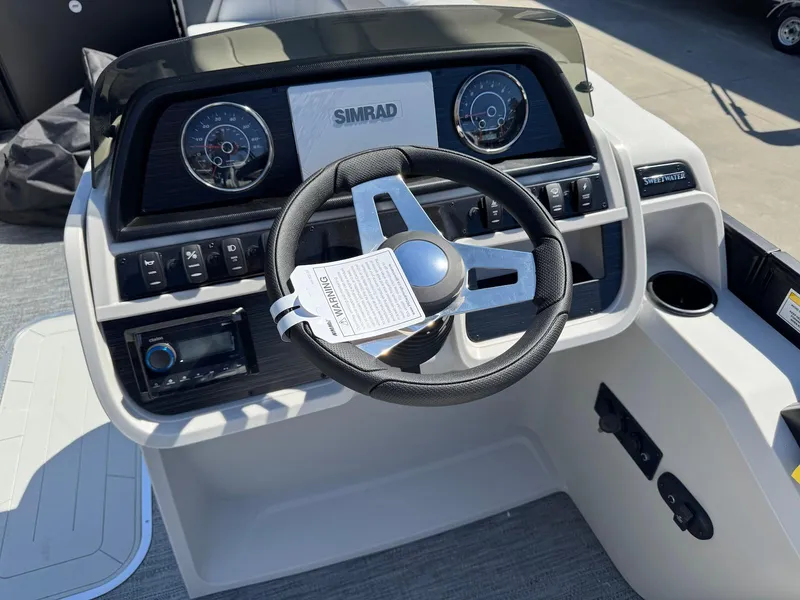 Slide: The Image of Steering console of 2025 Godfrey Sweetwater 2286 SFLC with Simrad display and controls. - 13
