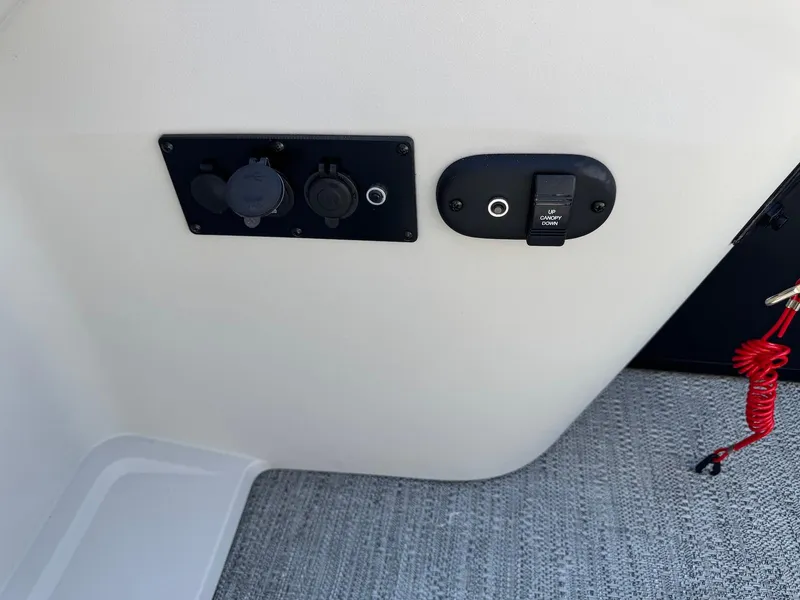 Slide: The Image of Control panel on 2025 Godfrey Sweetwater 2286 SFLC boat interior, featuring switches and outlets. - 14