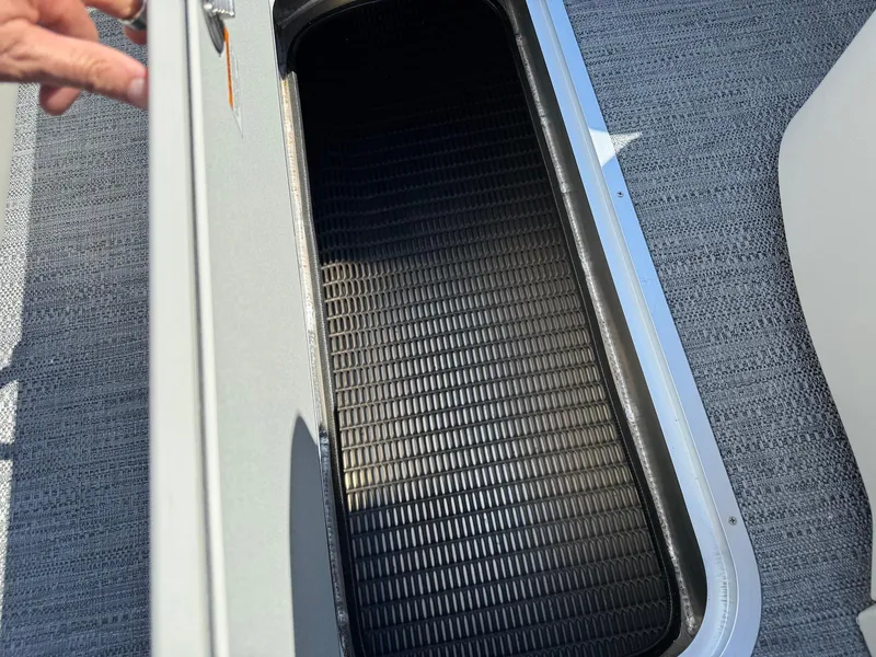 Slide: The Image of Open storage compartment on 2025 Godfrey Sweetwater 2286 SFLC boat, featuring textured interior. - 16
