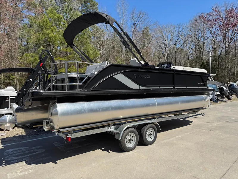 Slide: The Image of 2025 Godfrey Sweetwater 2286 SFLC pontoon boat on trailer, parked outdoors. - 3