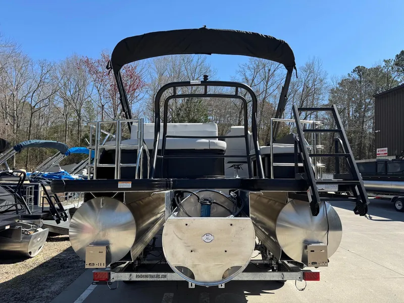 Slide: The Image of 2025 Godfrey Sweetwater 2286 SFLC pontoon boat, rear view, parked outdoors. - 4