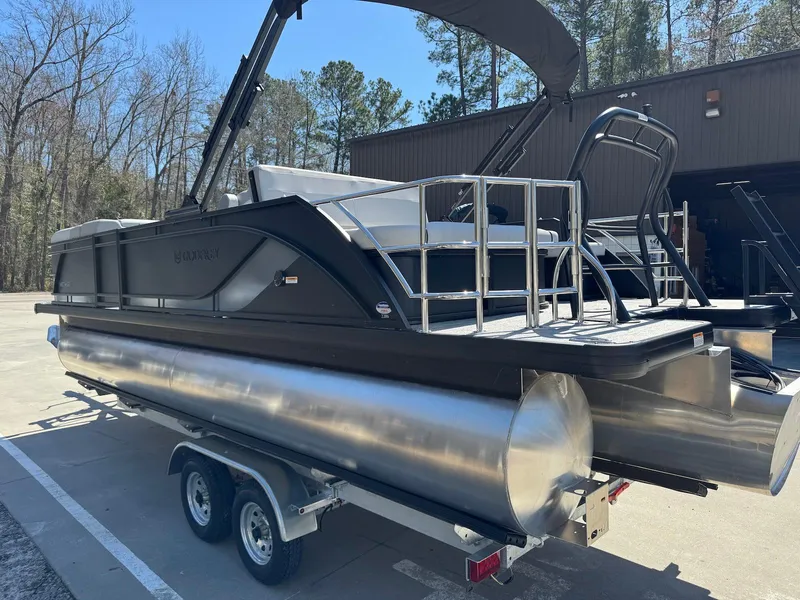 Slide: The Image of 2025 Godfrey Sweetwater 2286 SFLC pontoon boat on trailer, parked outdoors. - 5