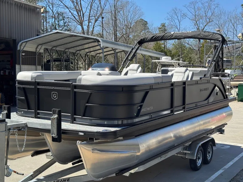 Slide: The Image of 2025 Godfrey Sweetwater 2286 SFLC pontoon boat on trailer, parked outdoors. - 6