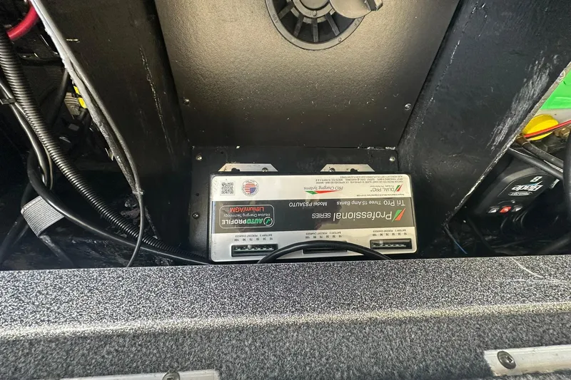 Slide: The Image of Battery compartment of 2025 Ranger Z185 boat with wiring and charger. - 100