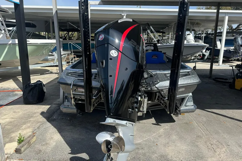 Slide: The Image of 2025 Ranger Z185 boat with powerful outboard motor in a marina setting. - 103