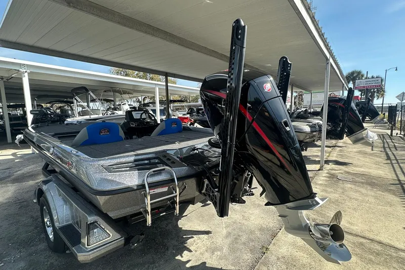 Slide: The Image of 2025 Ranger Z185 boat with powerful outboard motor in a marina setting. - 105