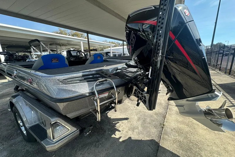 Slide: The Image of 2025 Ranger Z185 boat with powerful outboard motor, parked under a canopy. - 106