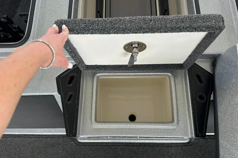 Slide: The Image of Hand opening storage compartment on 2025 Ranger Z185 boat. - 111