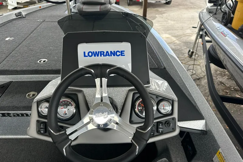 Slide: The Image of 2025 Ranger Z185 boat dashboard with Lowrance display and steering wheel. - 114