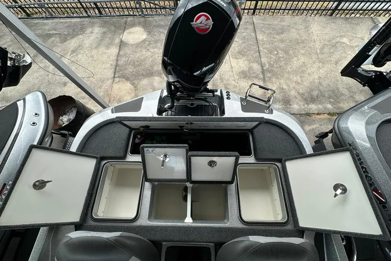 Slide: The Image of 2025 Ranger Z185 boat with open storage compartments and powerful outboard motor. - 120