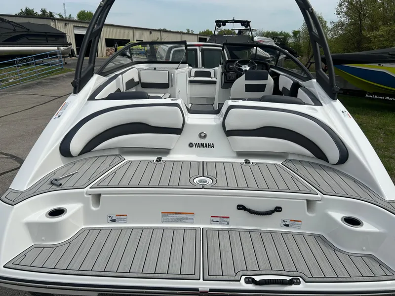 Slide: The Image of 2025 Yamaha Boats AR195, sleek design, spacious seating, modern features, docked outdoors. - 4