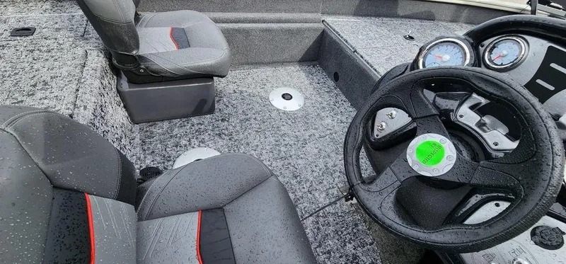 Slide: The Image of 2024 Tracker Pro Team 175 TF boat interior with steering wheel and seats. - 17