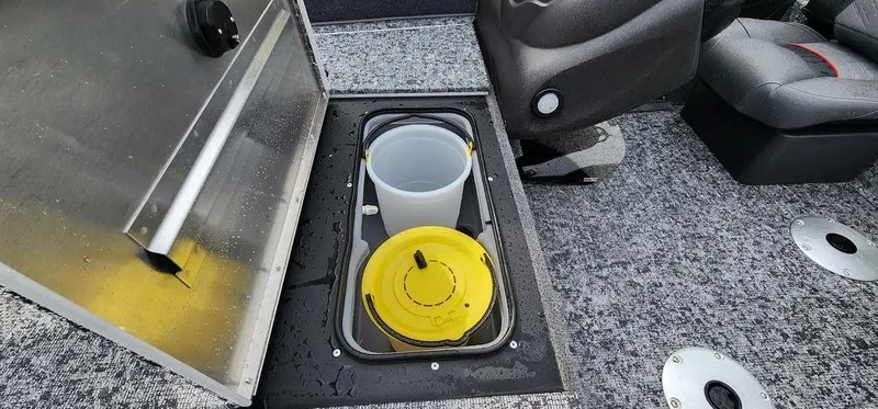 Slide: The Image of 2024 Tracker Pro Team 175 TF boat storage compartment with bucket and lid. - 23