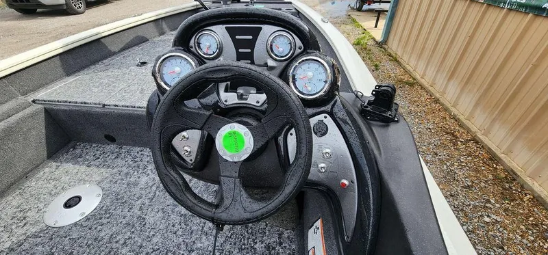 Slide: The Image of 2024 Tracker Pro Team 175 TF boat dashboard with steering wheel and gauges. - 8