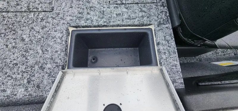 Slide: The Image of 2024 Tracker Pro Team 175 TF boat storage compartment with gray interior. - 9