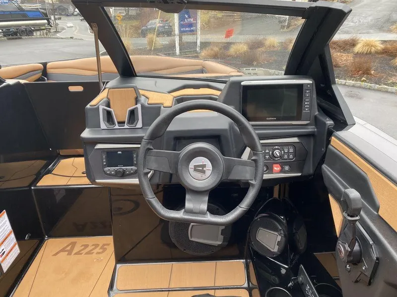 Slide: The Image of 2025 Axis A225 boat dashboard with steering wheel and control panel. - 11