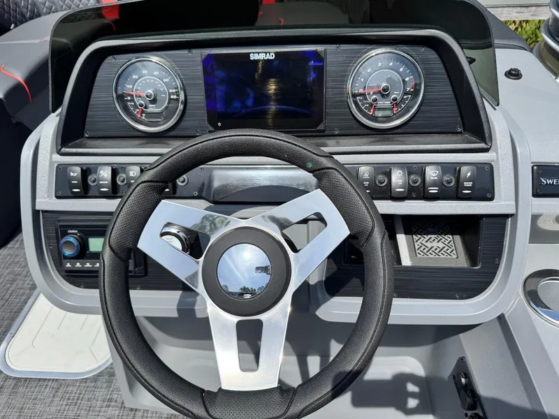 Slide: The Image of Steering console of 2025 Godfrey Sweetwater 2286 SFLC boat with modern controls and gauges. - 15