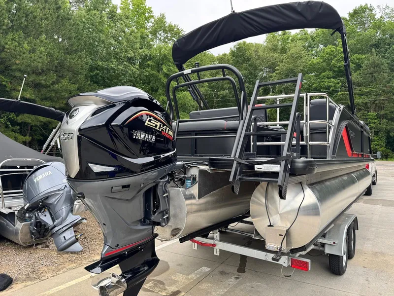 Slide: The Image of 2025 Godfrey Sweetwater 2286 SFLC pontoon boat with Yamaha outboard motor on trailer. - 2