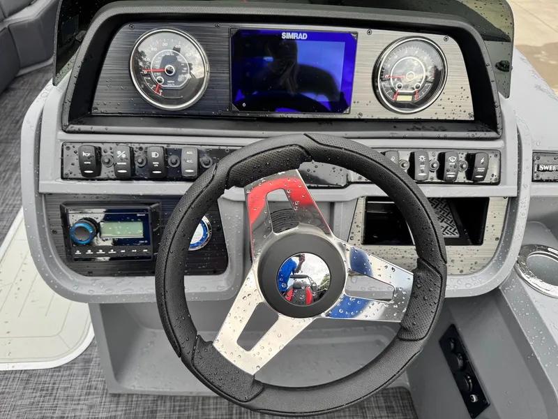 Slide: The Image of Steering console of 2025 Godfrey Sweetwater 2286 SFLC boat with modern controls and gauges. - 27