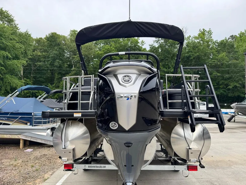 Slide: The Image of 2025 Godfrey Sweetwater 2286 SFLC pontoon boat, rear view, parked on trailer. - 3