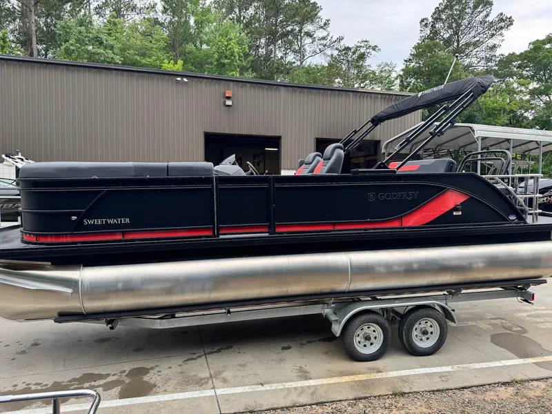 Slide: The Image of 2025 Godfrey Sweetwater 2286 SFLC pontoon boat on trailer, parked outdoors. - 5
